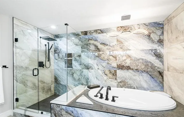 a bathroom with a bathtub and shower