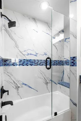 a bathroom with a bathtub and a shower