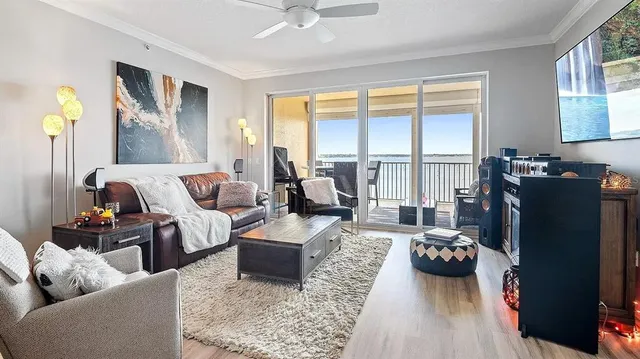 a living room with furniture fireplace and a large window