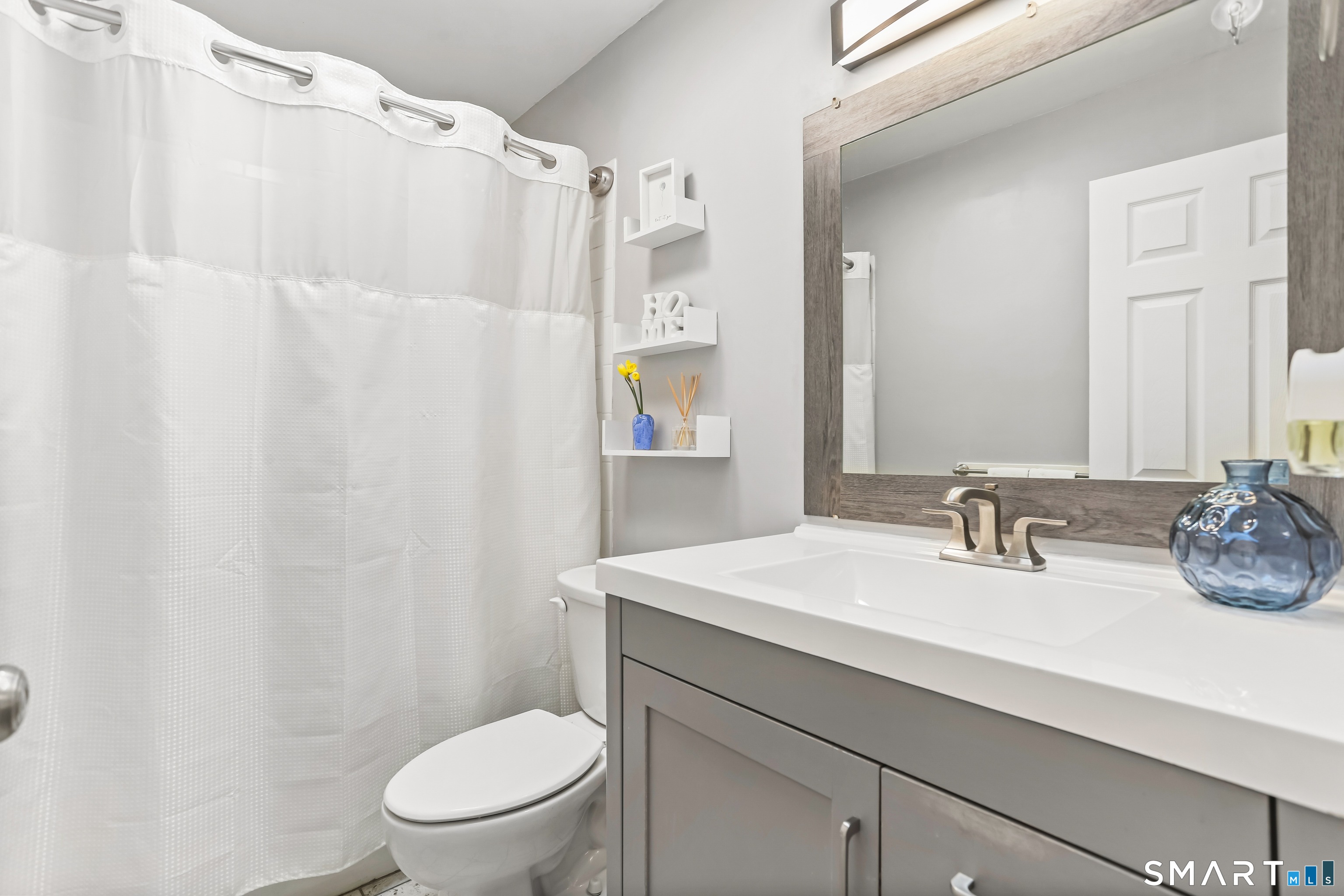 40 Sullivan Place Bridgeport, CT 06610 - Photo 14 of 21 a bathroom with a sink a toilet and shower curtain