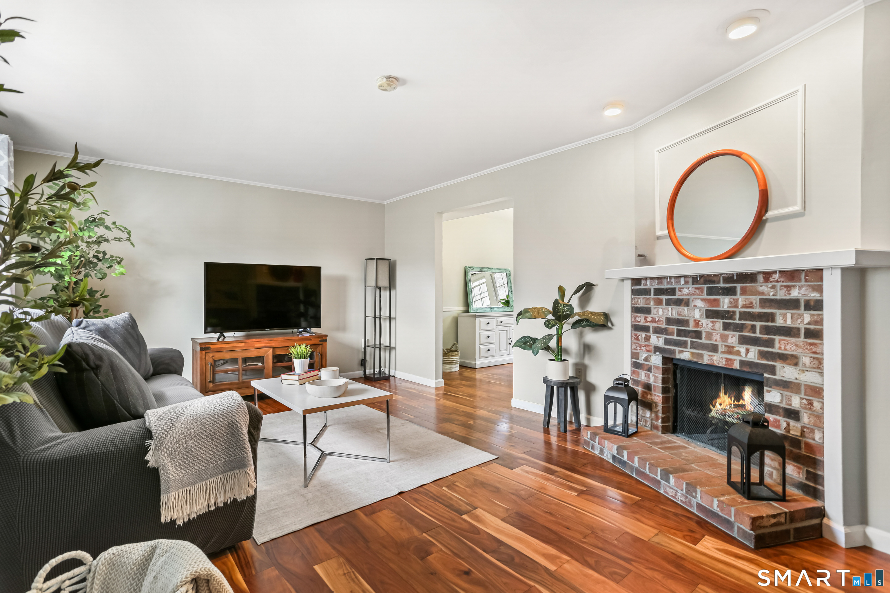 40 Sullivan Place Bridgeport, CT 06610 - Photo 4 of 21 a living room with furniture a flat screen tv and a fireplace