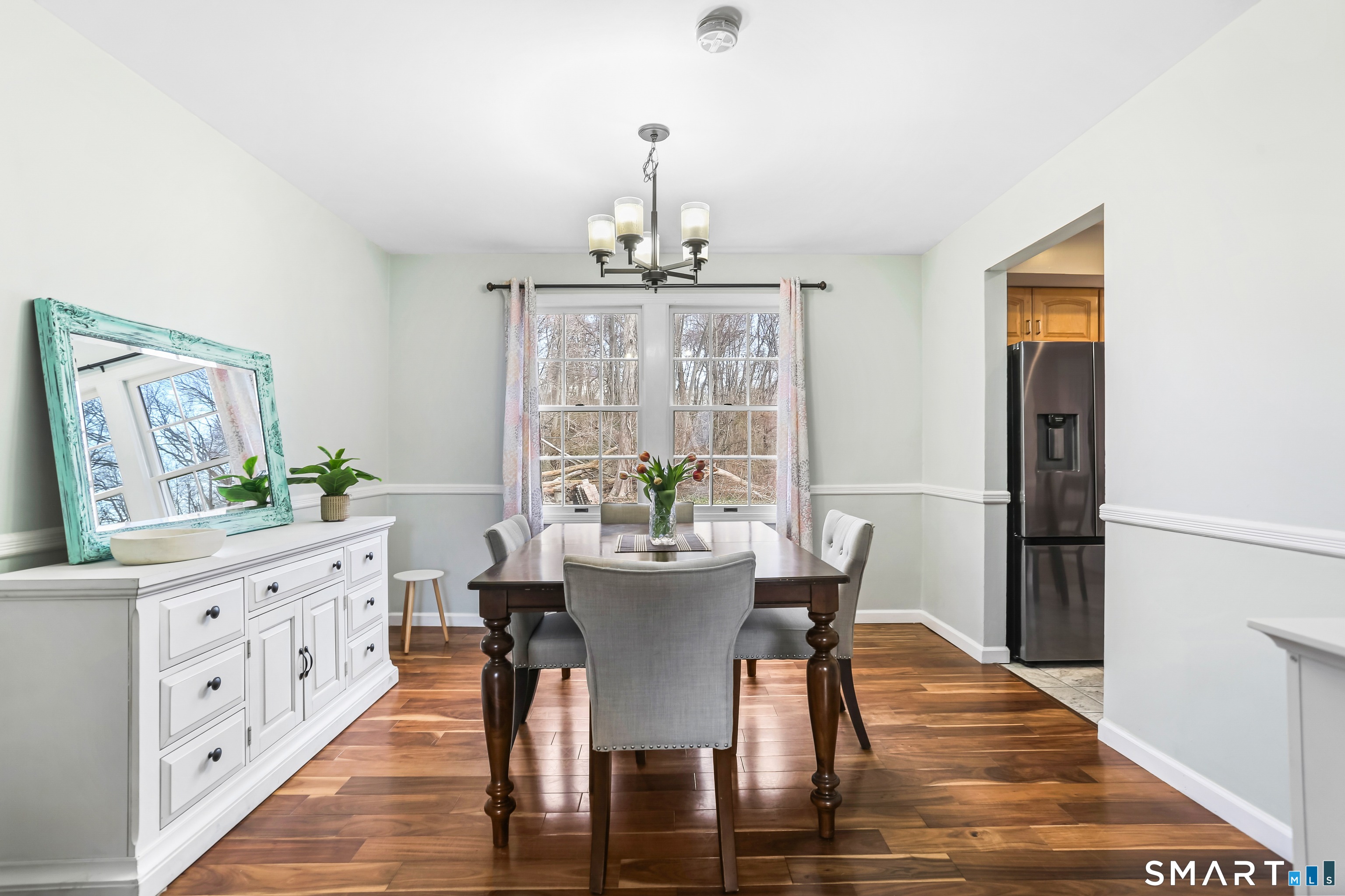 40 Sullivan Place Bridgeport, CT 06610 - Photo 8 of 21 a dining room with furniture a chandelier and wooden floor