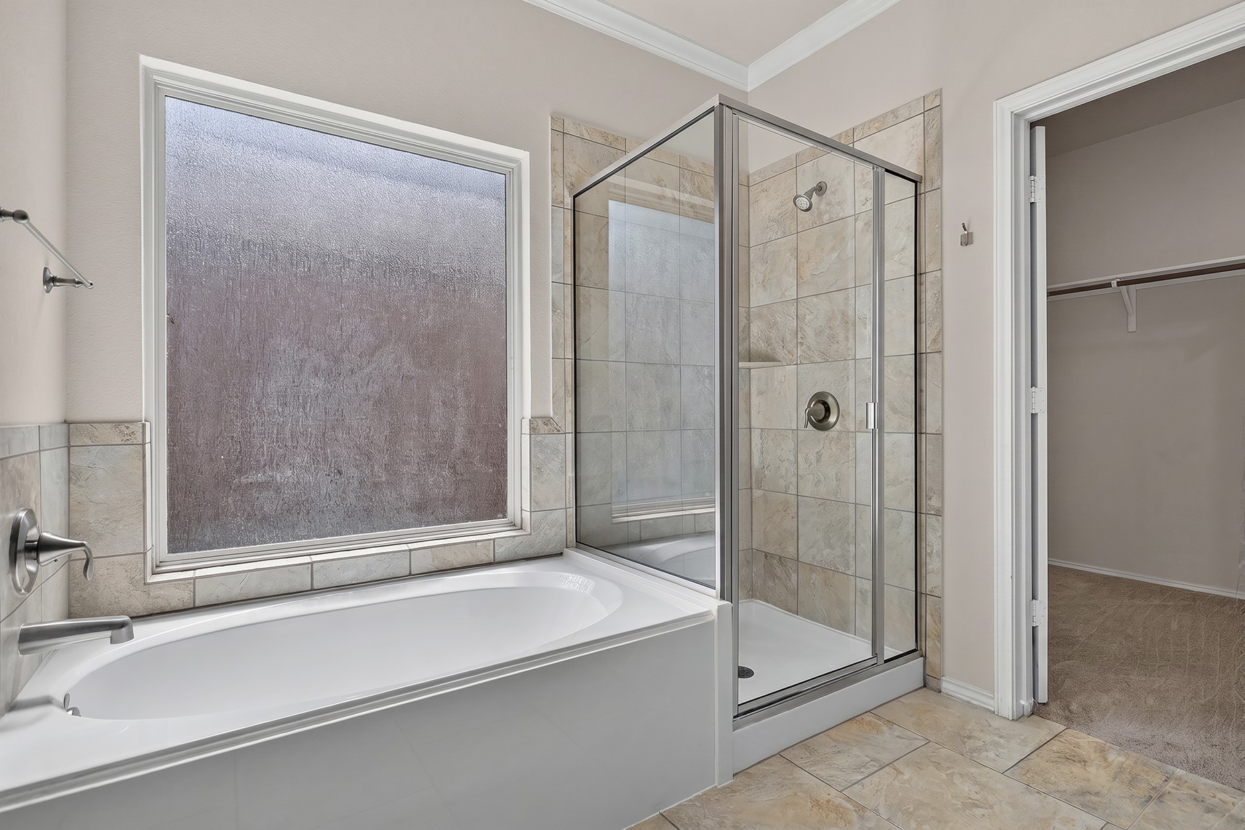 4601 Chestnut Meadows Bend Georgetown, TX 78626 - Photo 18 of 35 A well-appointed bath features a deep soaking tub, separate glass-enclosed shower, and convenient closet access.