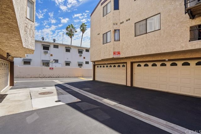 a view of a kitchen with stainless steel appliances granite countertop a stove and a kitchen island