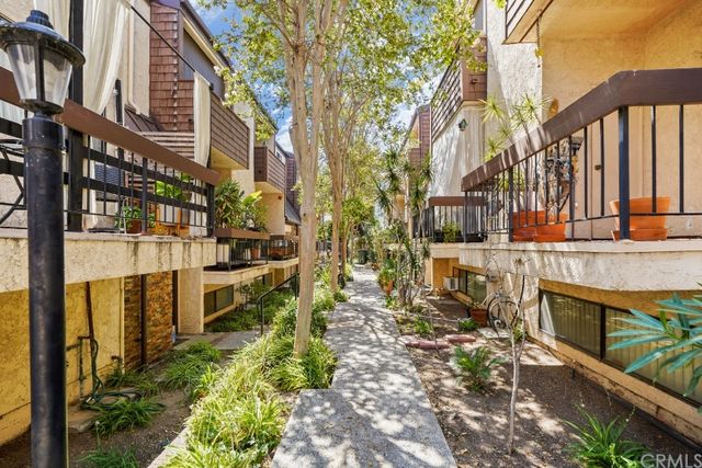 a backyard of a building with barbeque oven and outdoor seating
