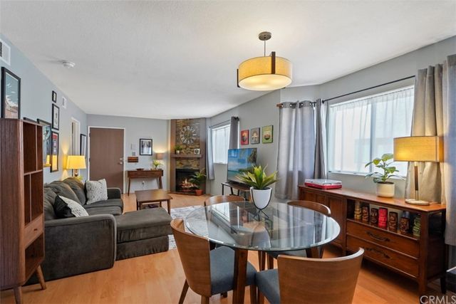 a living room with furniture a window and a table
