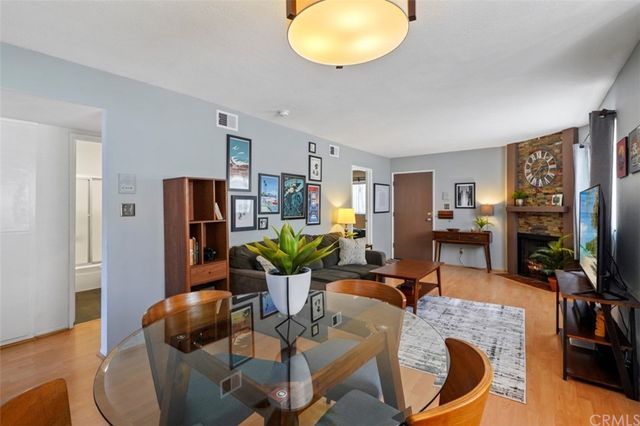 a living room with furniture a dining table and a flat screen tv
