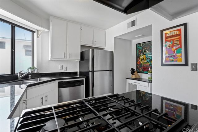 a kitchen with a refrigerator and a sink
