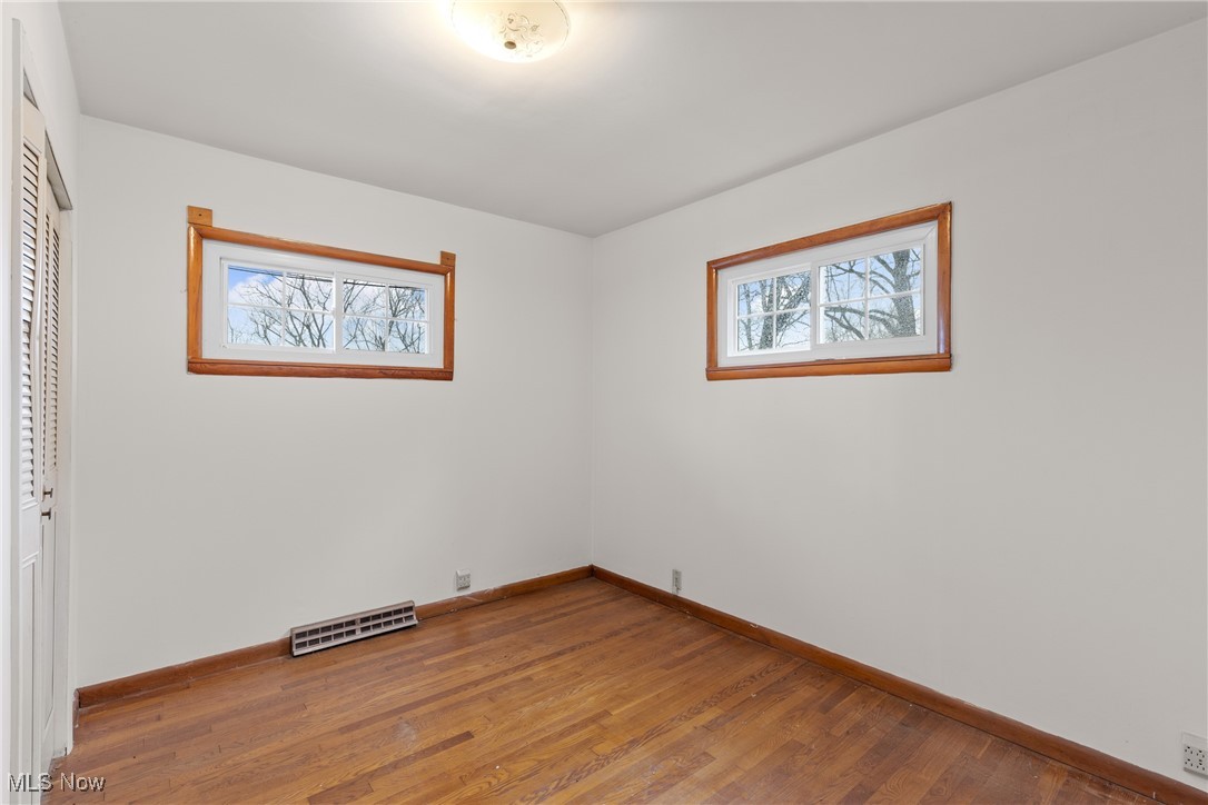 54885 Mt Victory Road Powhatan Point, OH 43942 - Photo 16 of 32 Empty room with plenty of natural light and wood finished floors