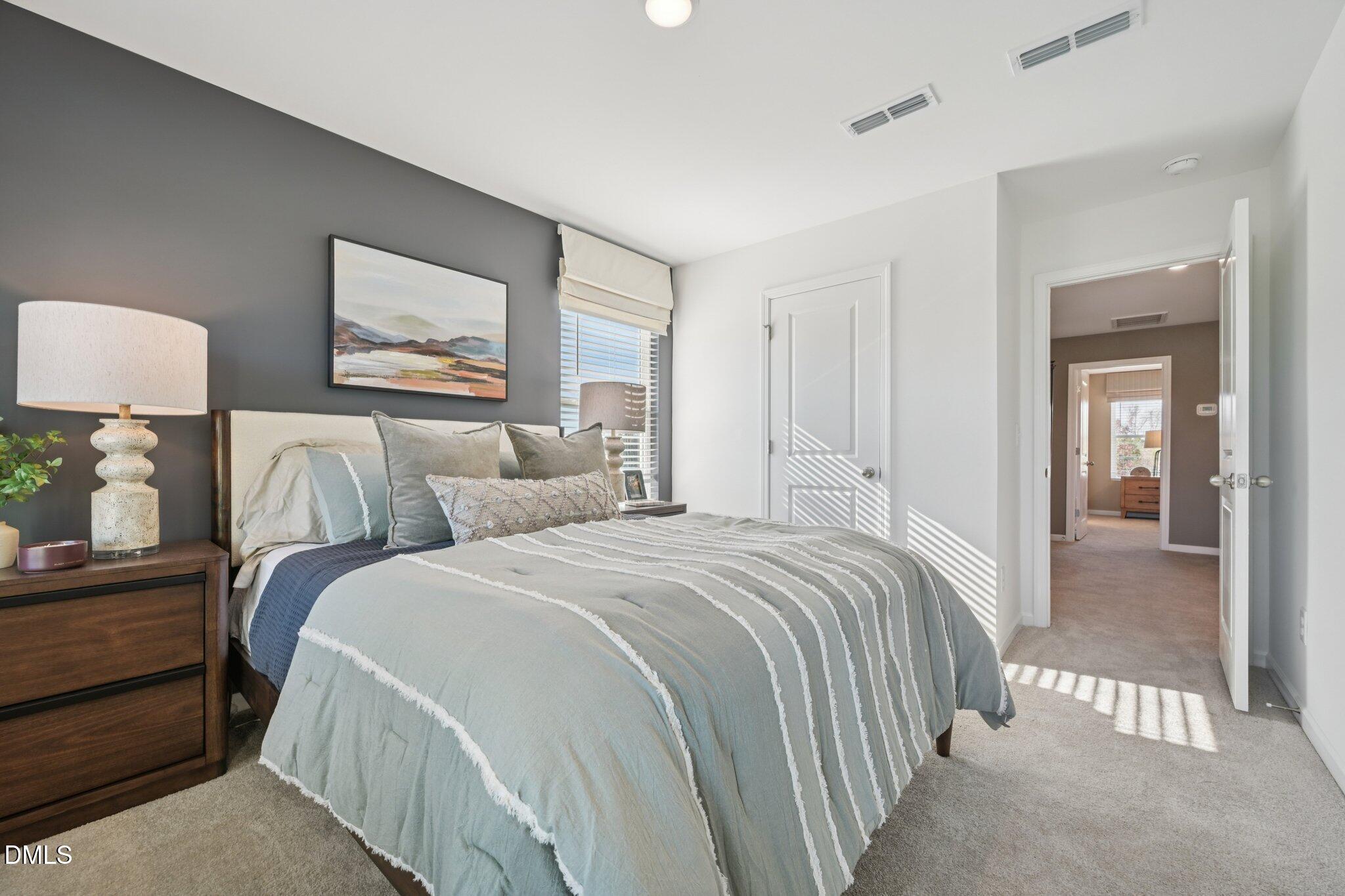 1623 Mirth Court Rolesville, NC 27571 - Photo 12 of 29 a bedroom with bed and a night stand