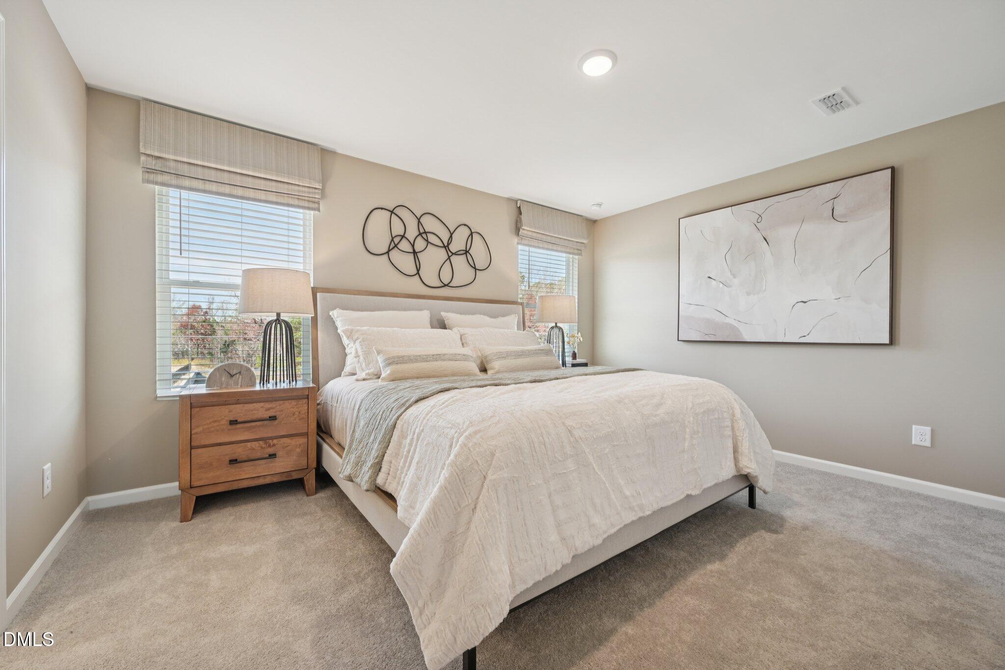1623 Mirth Court Rolesville, NC 27571 - Photo 9 of 29 a bedroom with a bed and painting on the wall