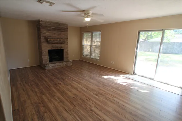 wooden floor in an empty room with a fireplace