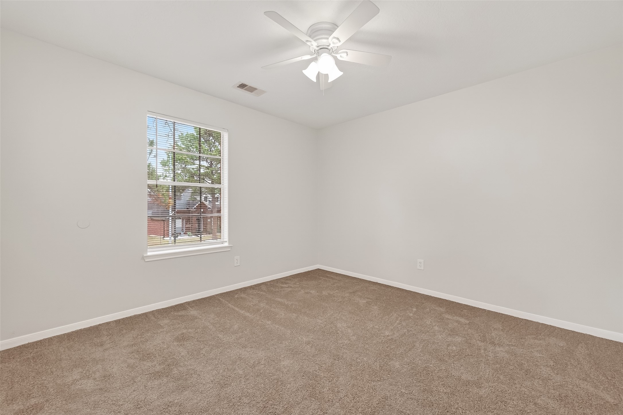 5439 Baslow Drive Katy, TX 77449 - Photo 17 of 31 an empty room with a window and a fan