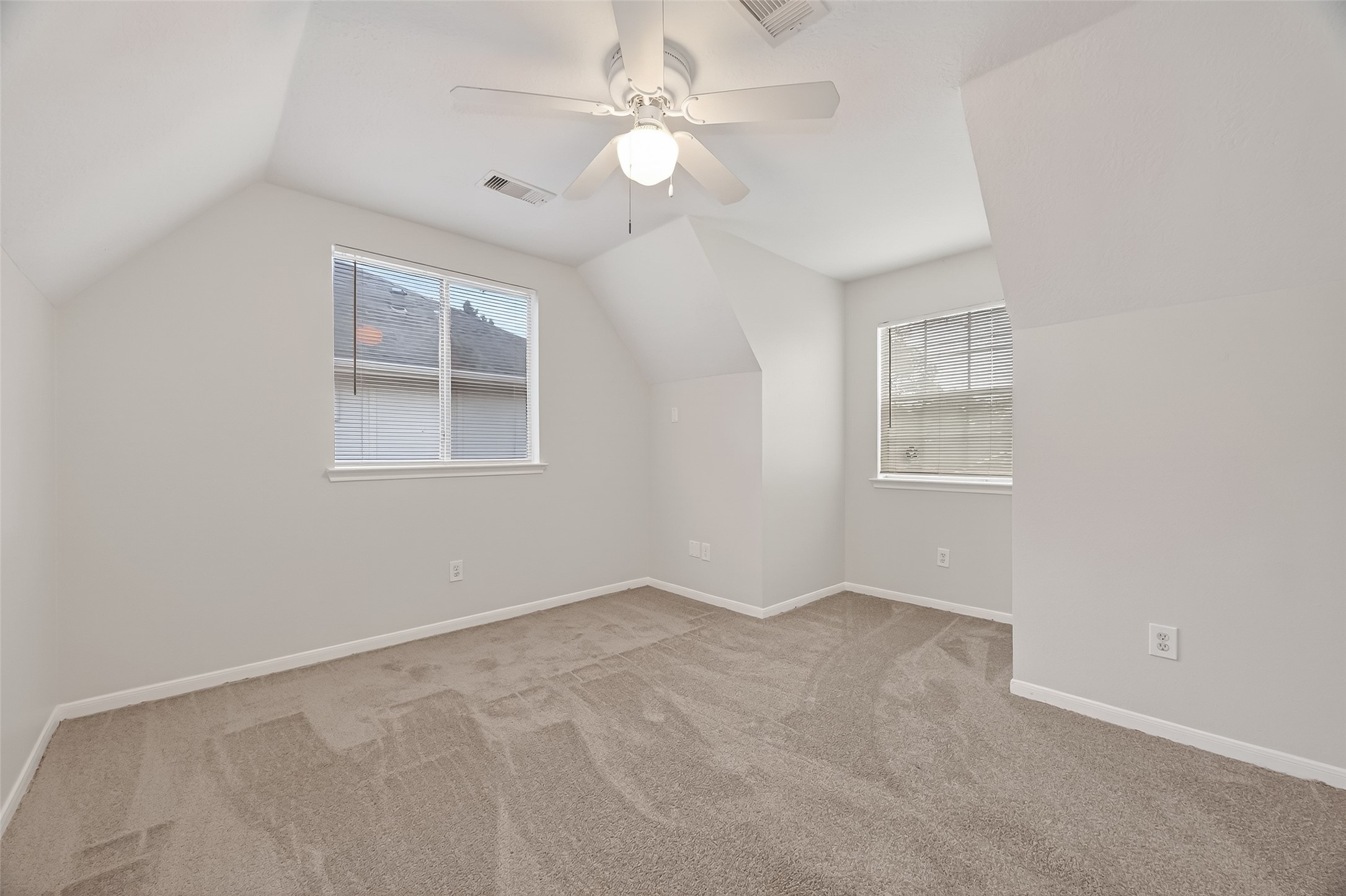 5439 Baslow Drive Katy, TX 77449 - Photo 22 of 31 an empty room with windows and fan