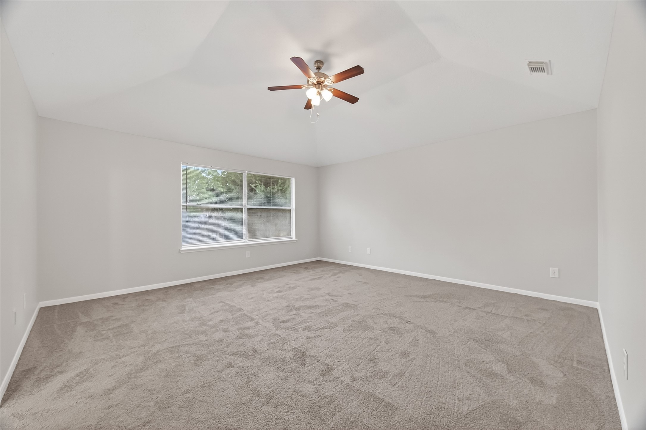 5439 Baslow Drive Katy, TX 77449 - Photo 25 of 31 an empty room with windows and fan