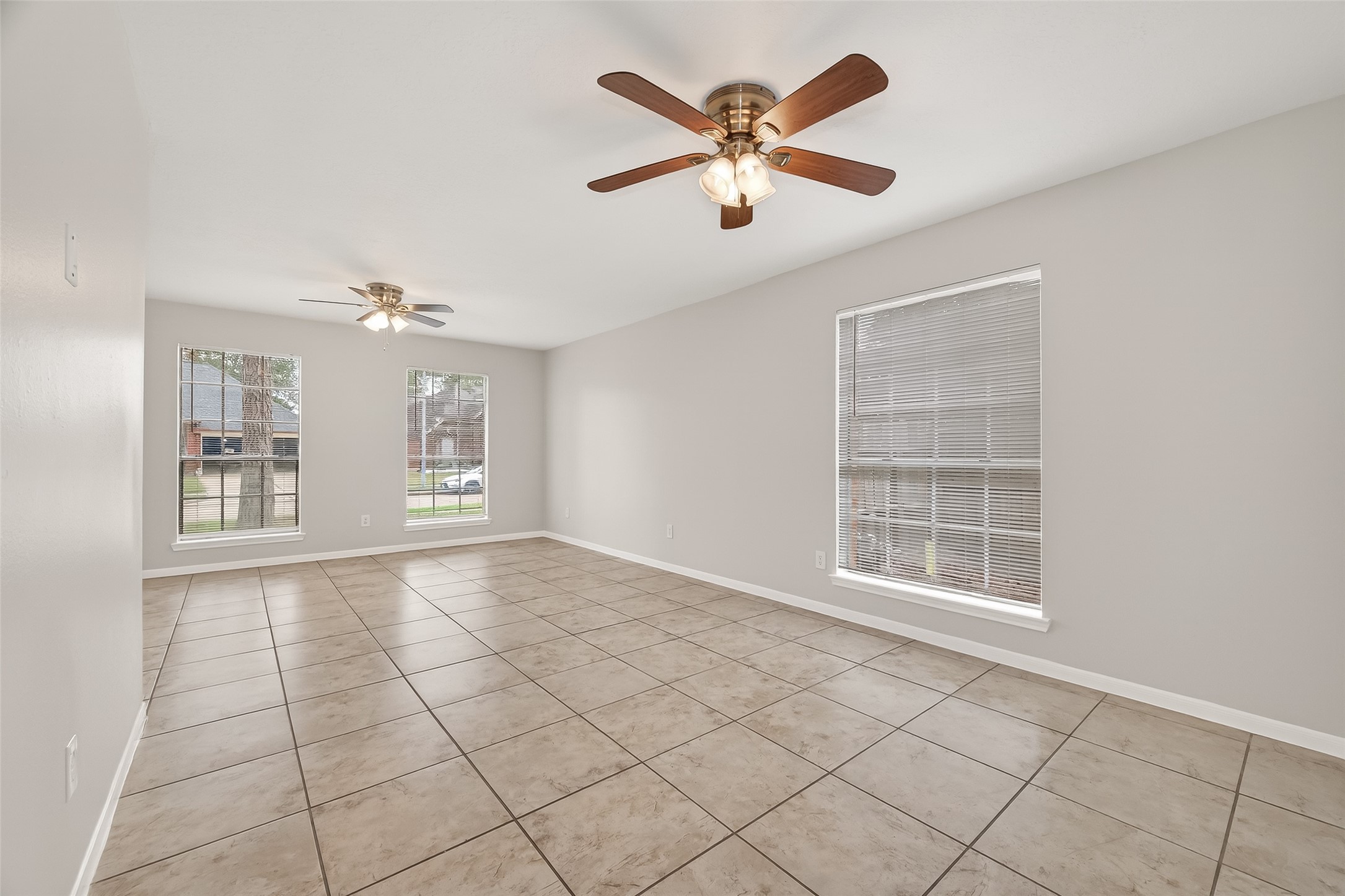 5439 Baslow Drive Katy, TX 77449 - Photo 6 of 31 an empty room with windows and ceiling fan