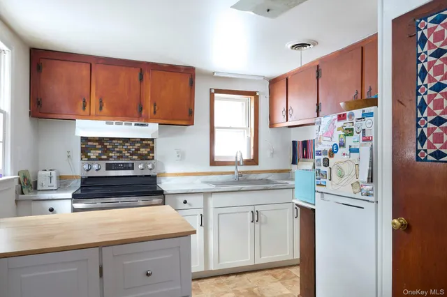 a kitchen with stainless steel appliances granite countertop a stove and a sink