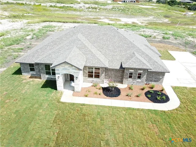 a view of a house with backyard and swimming pool