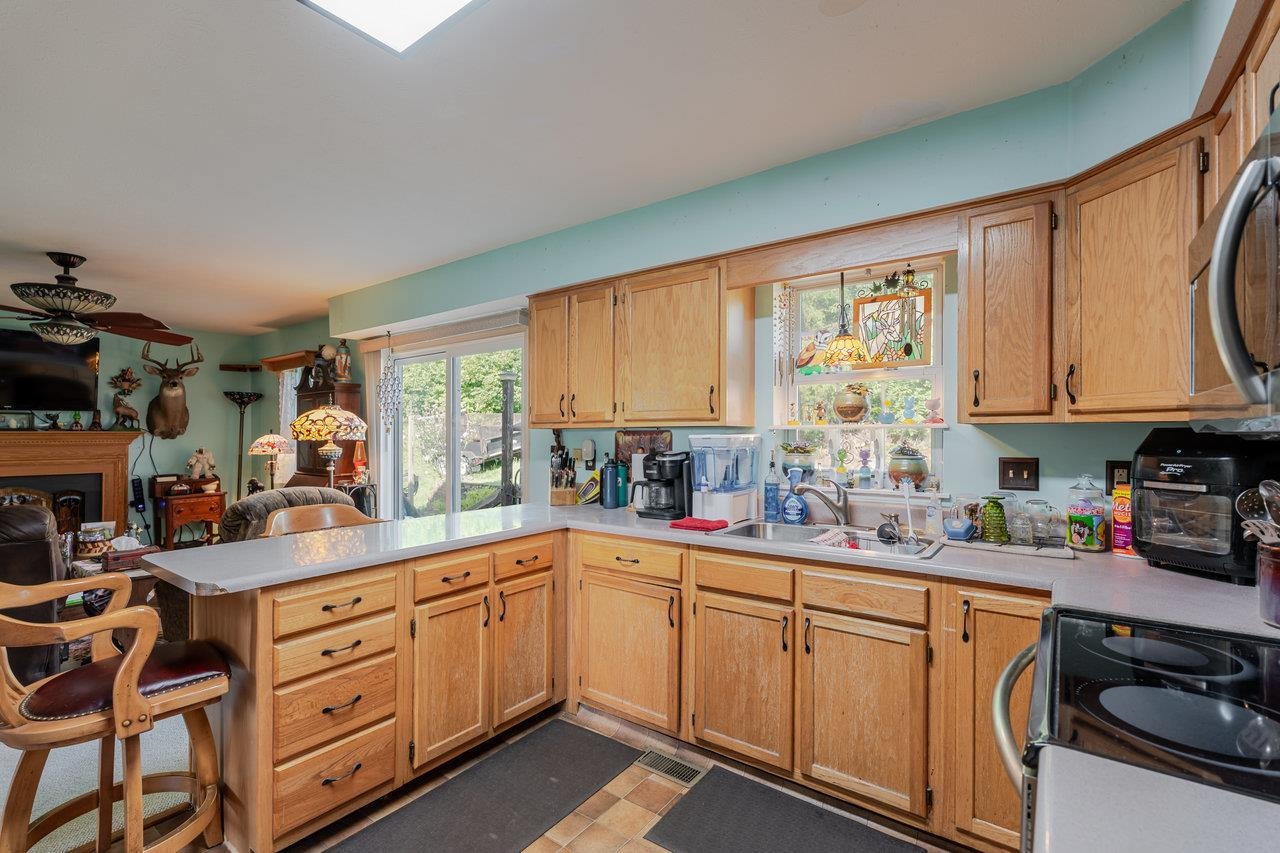 107 Orchard Road Staunton, VA 24401 - Photo 10 of 44 a kitchen with a sink window and cabinets