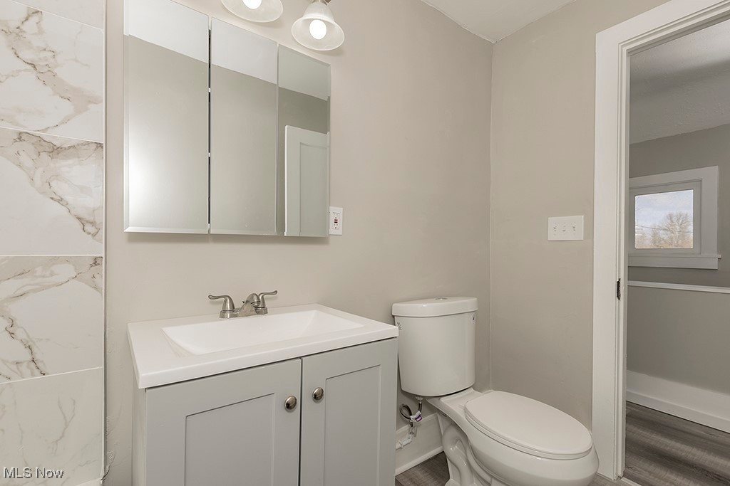12447 Chillicothe Road Chesterland, OH 44026 - Photo 9 of 42 Bathroom featuring vanity, hardwood / wood-style flooring, and toilet