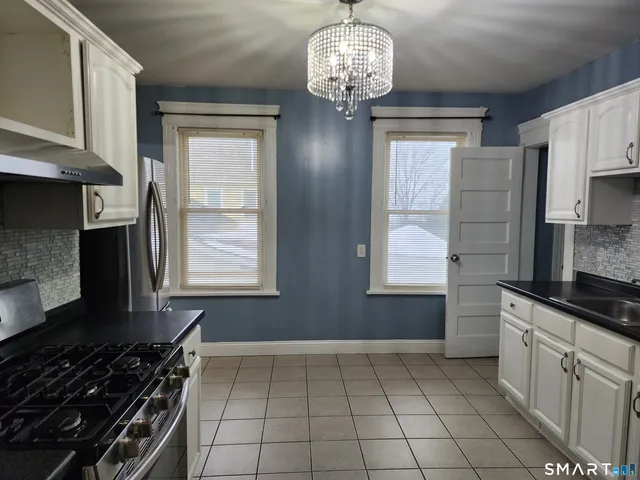 a kitchen with stainless steel appliances a stove and a refrigerator