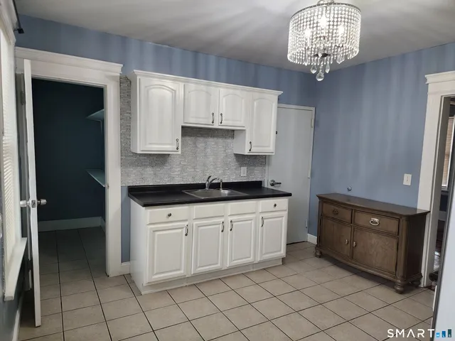 a kitchen with stainless steel appliances granite countertop a sink and cabinets