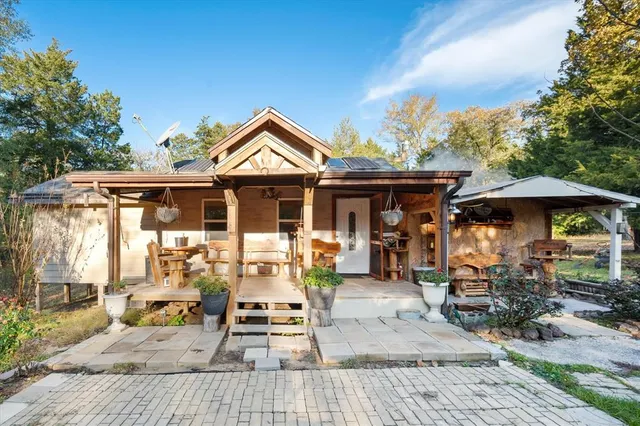 a backyard of a house with table and chairs