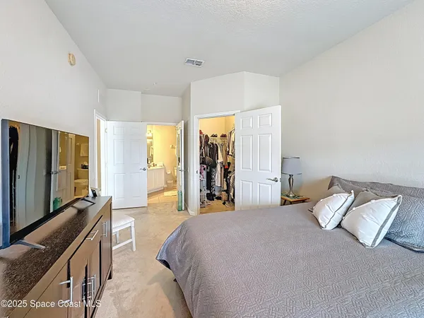 a bed room with a bed and a television