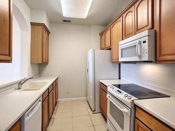 a kitchen with a stove microwave and sink