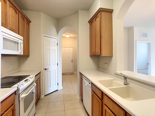 a kitchen with a sink stove and cabinets