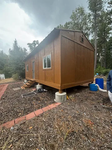 a backyard of a house with wooden fence