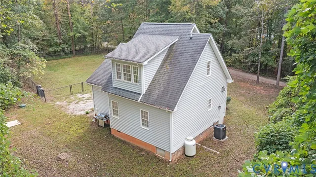 an aerial view of a house with a yard