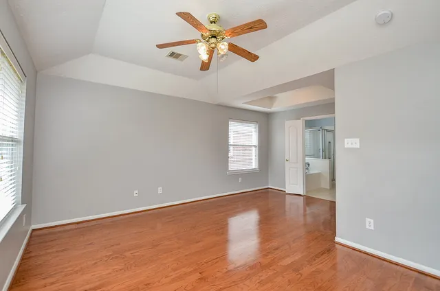 wooden floor in an empty room with a window