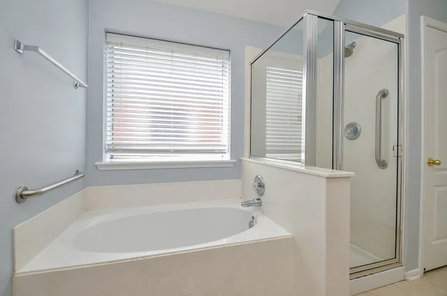 a white bath tub sitting next to a window