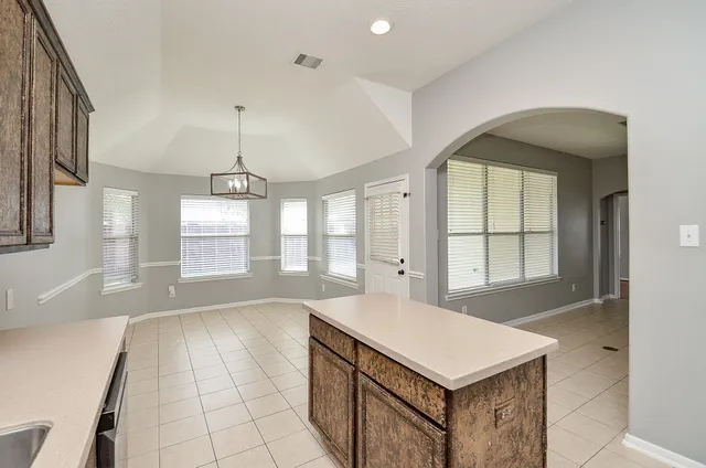 a kitchen with a stove a sink a refrigerator and window