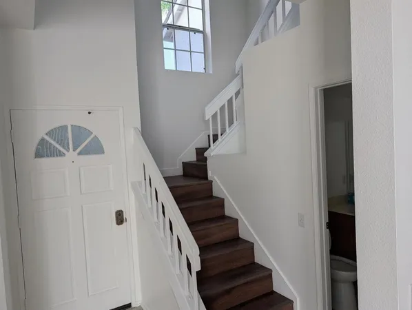 a view of entryway and hall with wooden floor