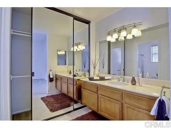 a bathroom with a sink a large mirror and a shower