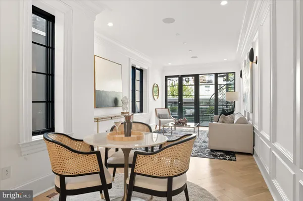a dining room with furniture and wooden floor