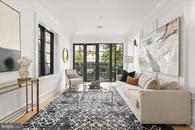 a living room with furniture a rug and a window