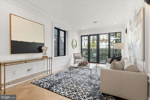 a living room with furniture a rug and a window