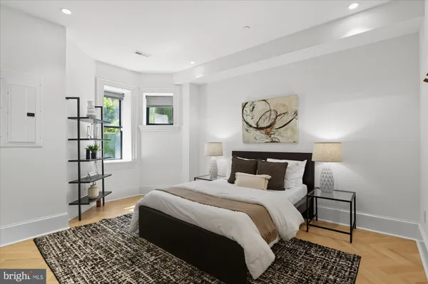 a bedroom with a bed and wooden floor