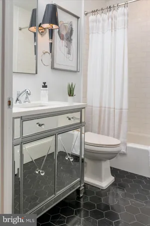 a view of staircase with lots of frames on wall and windows