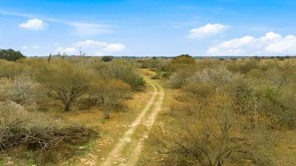 an aerial view of residential houses with city view