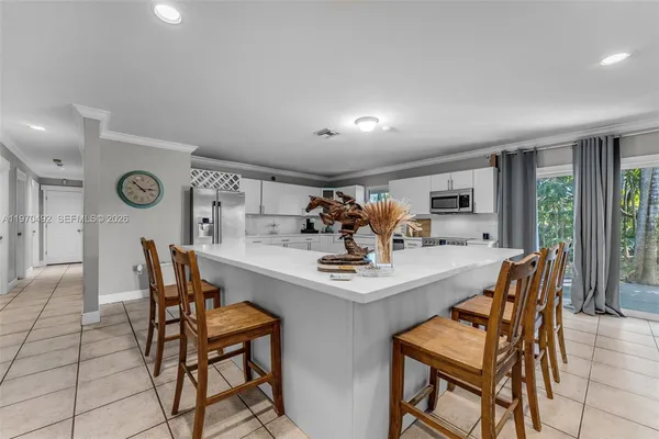 a kitchen with stainless steel appliances granite countertop a refrigerator and a stove top oven