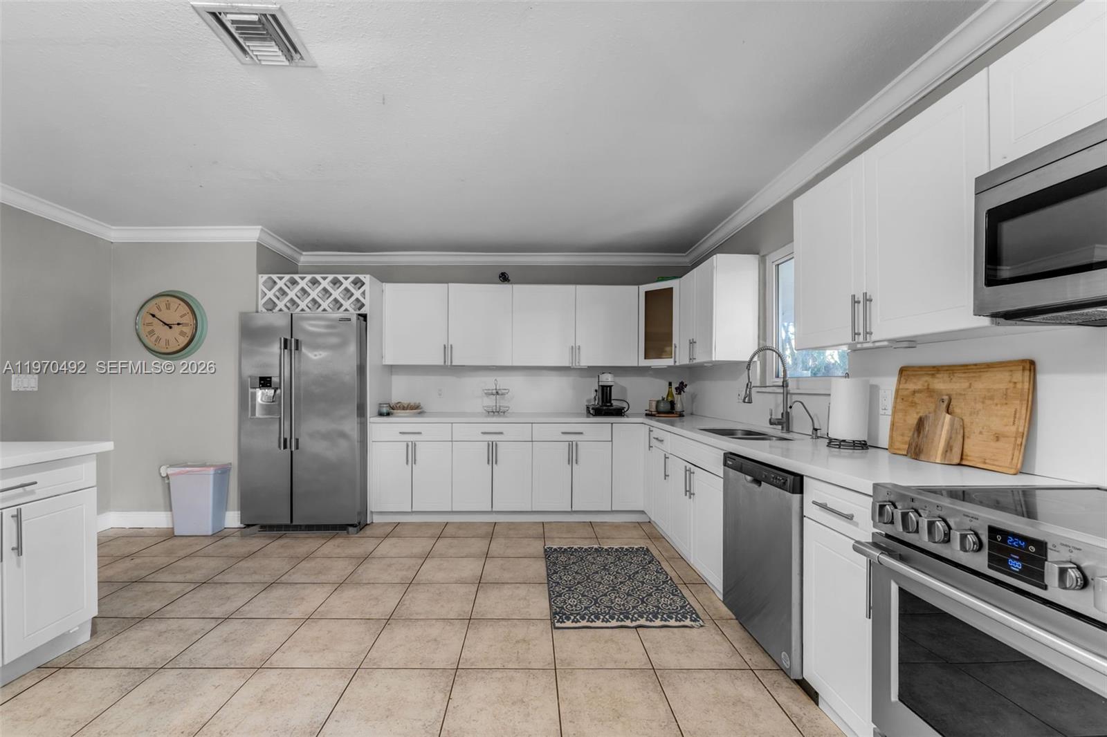 20076 Southwest 190th Street Miami, FL 33187 - Photo 13 of 32 a kitchen with stainless steel appliances a refrigerator sink and cabinets