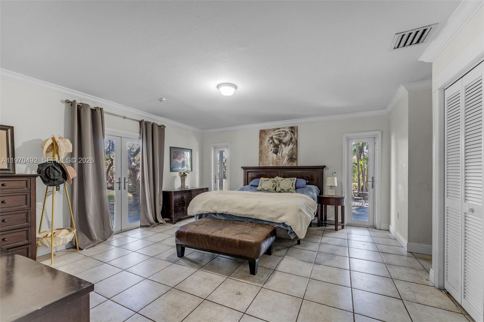 20076 Southwest 190th Street Miami, FL 33187 - Photo 14 of 32 a bedroom with a bed and a painting on the wall