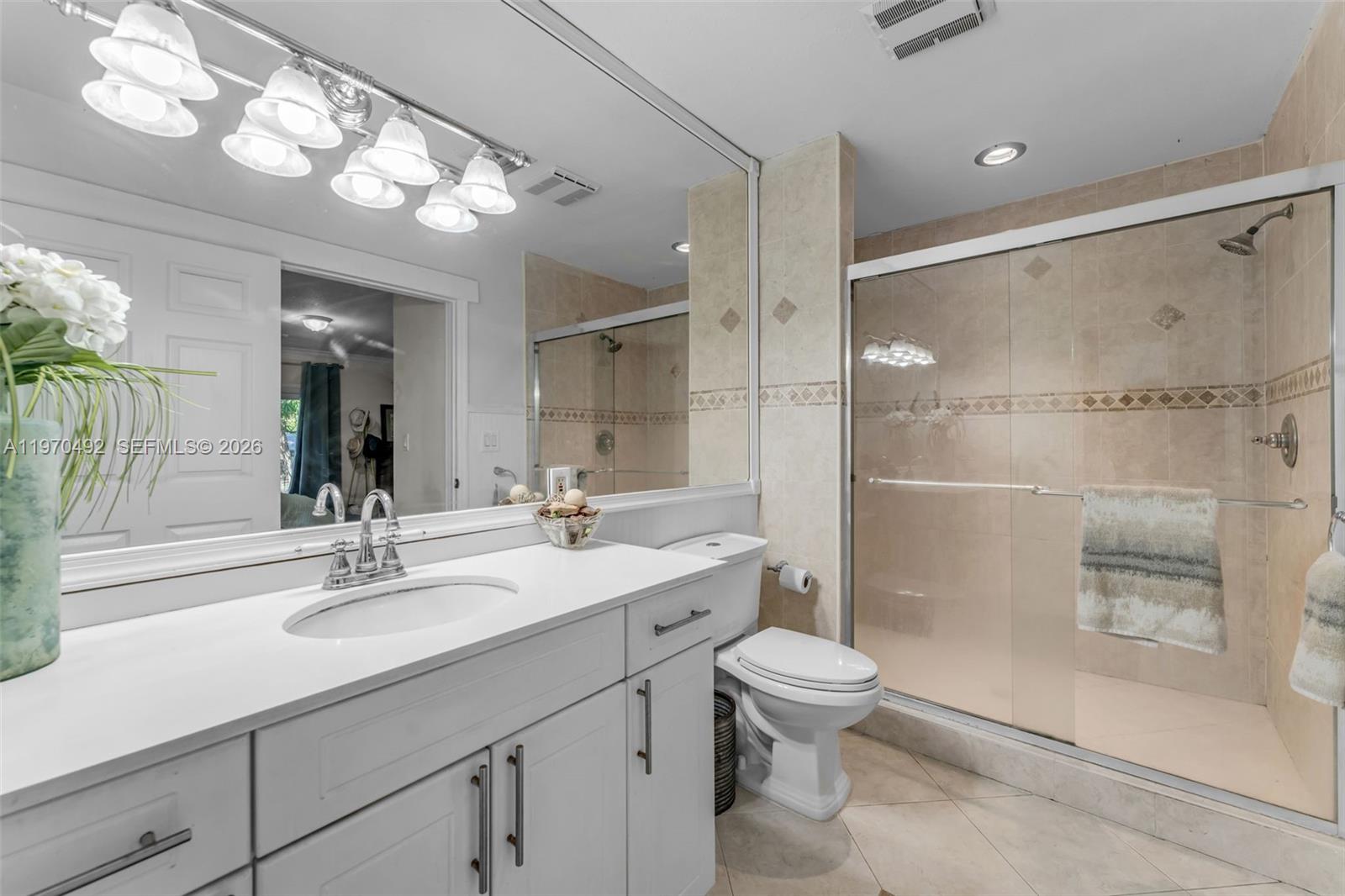 20076 Southwest 190th Street Miami, FL 33187 - Photo 15 of 32 a bathroom with a sink a toilet and shower
