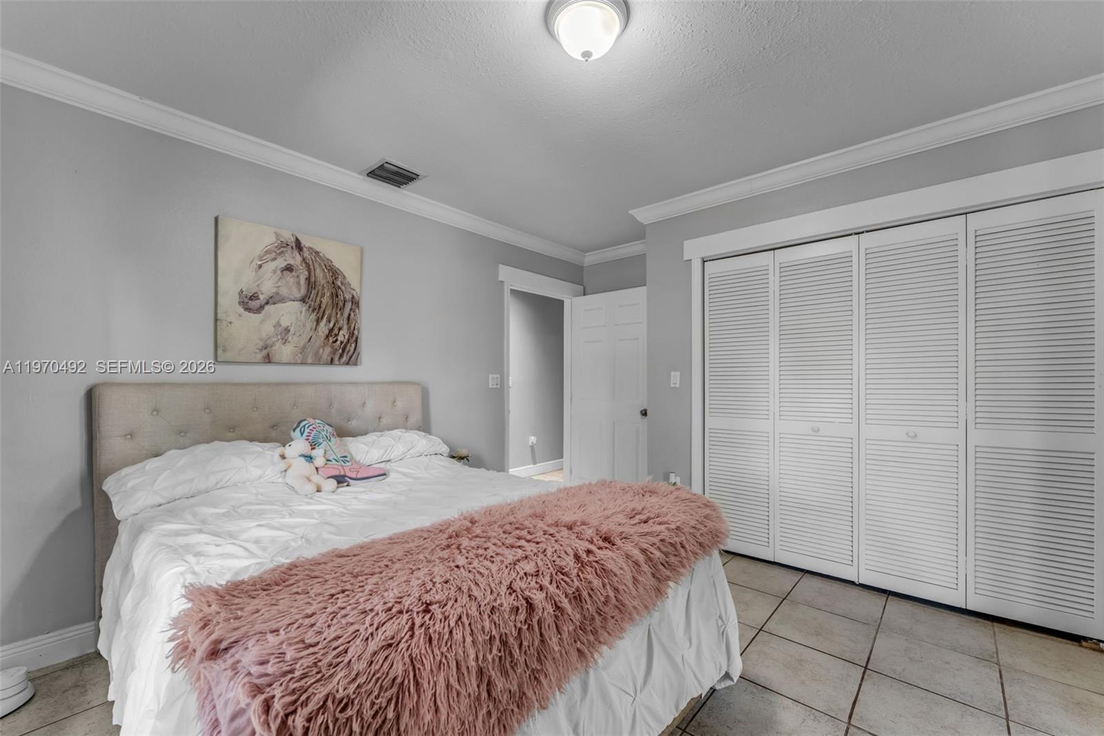 20076 Southwest 190th Street Miami, FL 33187 - Photo 16 of 32 a bedroom with a bed and a window