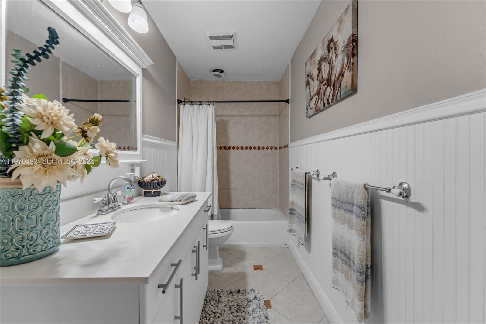 20076 Southwest 190th Street Miami, FL 33187 - Photo 17 of 32 a bathroom with a sink a mirror and a shower