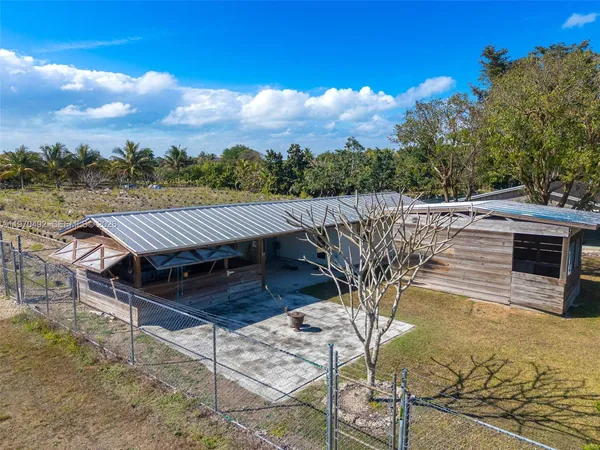 a view of a chairs and table in the balcony